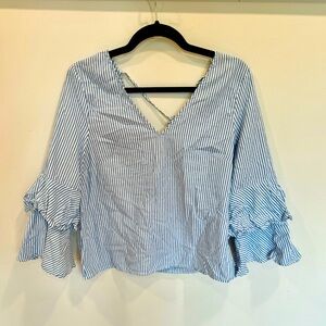 Blue and white striped blouse. Low back tie. Tiered sleeve detail.